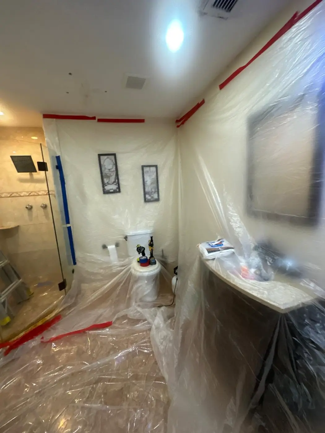 Bathroom sealed off with plastic sheeting and tape during remediation